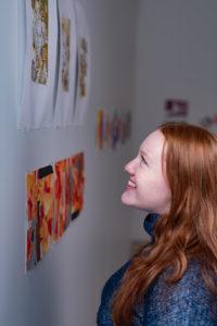 Trinity college student admiring artwork on campus